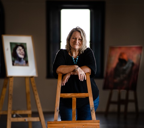 Gina Davey with her paintings