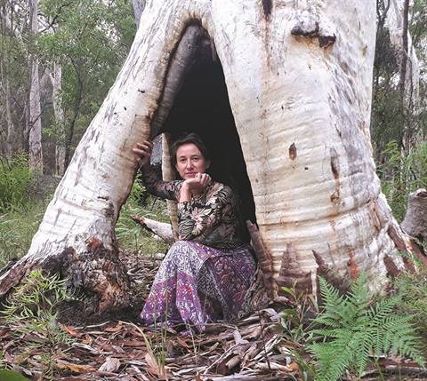 Nicole Jakins sitting in tree cavity