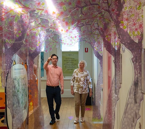 Joy Duke and George Seymour walking in gardens