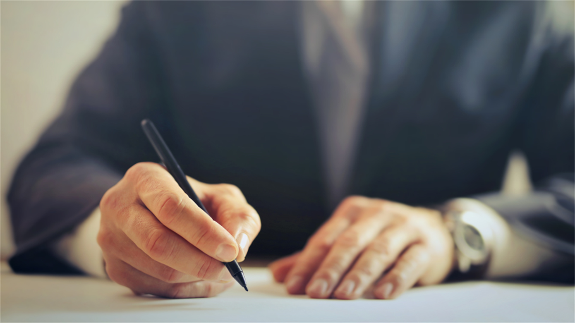 Close up of hands holding pen ready to write Close up of hands holding pen ready to write