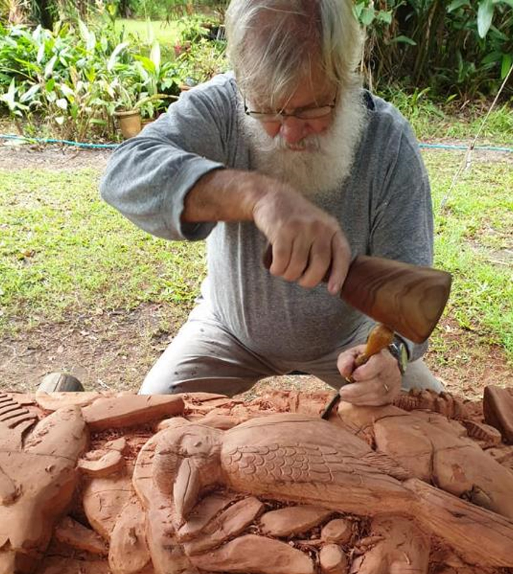 Artist Willie Paes chisels intricate details into the Peace Pole. Photo: Courtesy Maryborough-Sunrise Club.