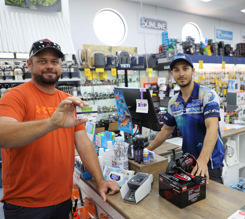 Ready to fish …. Ewan Walsh of Hervey Bay picks up the final supplies for a fishing trip to Swains Reef.