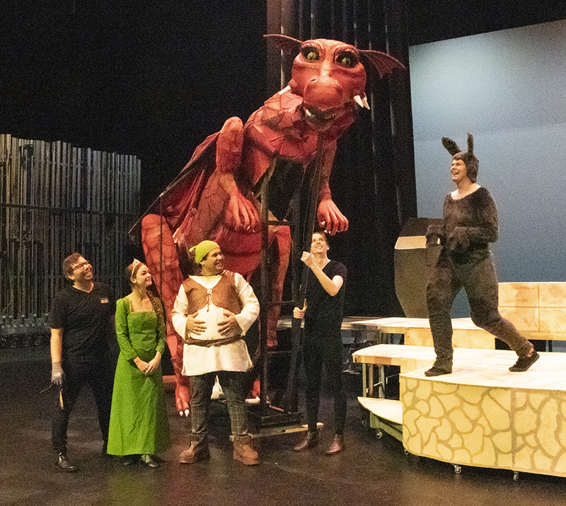 The Cast of Shrek The Musical rehearse with Scarlet the Dragon.